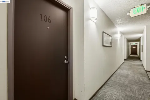 a view of a hallway with closet and a living room