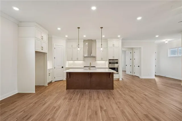 a large kitchen with stainless steel appliances kitchen island a large counter top and a sink