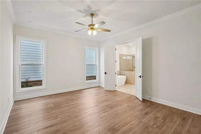 a view of a livingroom with wooden floor and a ceiling fan