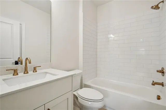 a bathroom with a sink a toilet and bathtub