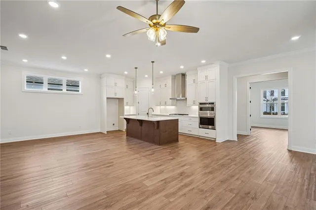 a view of kitchen with kitchen island wooden floor center island and appliances