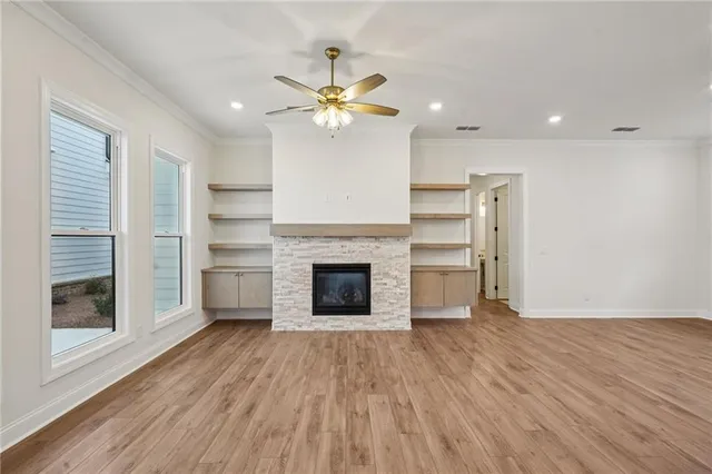 a view of a room with a fireplace and wooden floor