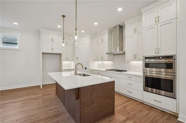 a kitchen with a sink stove and cabinets