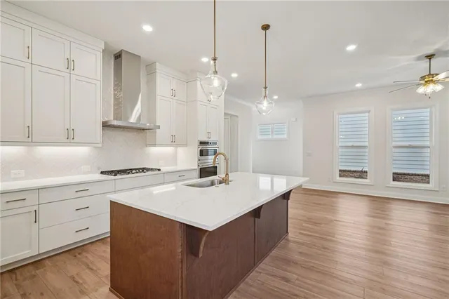 a kitchen with kitchen island a sink stove and wooden floor