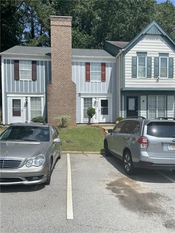 a view of a car parked in front of a brick house