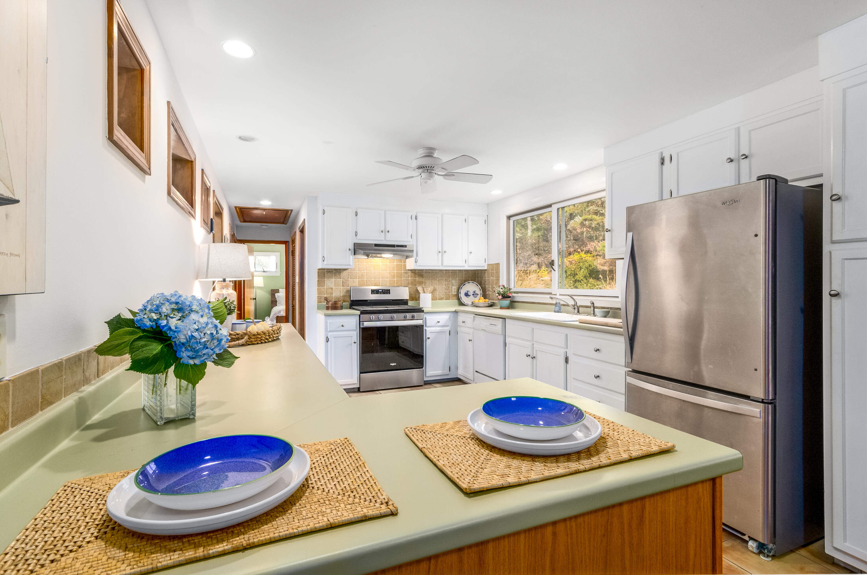 3 Tern Road Harwich, MA 02645 - Photo 11 of 44 a kitchen with stainless steel appliances granite countertop a refrigerator stove and white cabinets