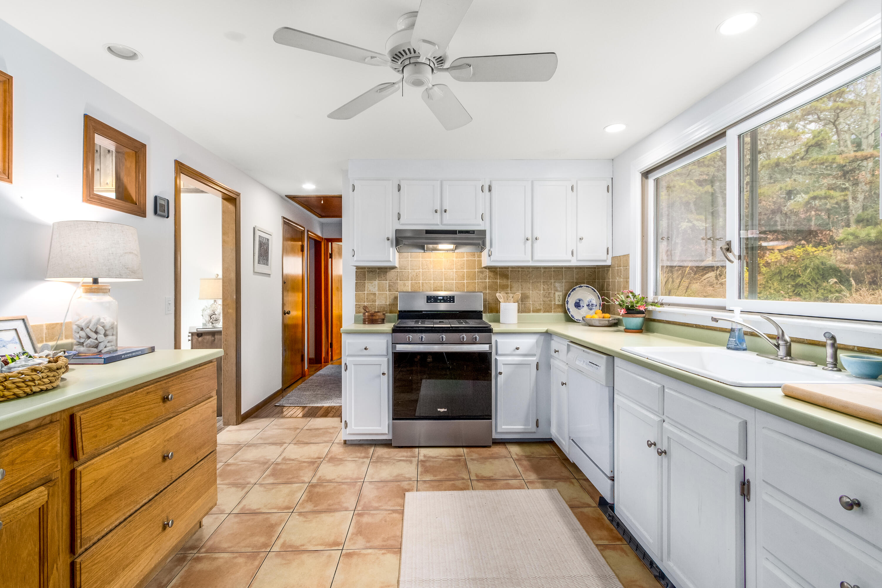 3 Tern Road Harwich, MA 02645 - Photo 12 of 44 a kitchen with granite countertop a stove sink and cabinets