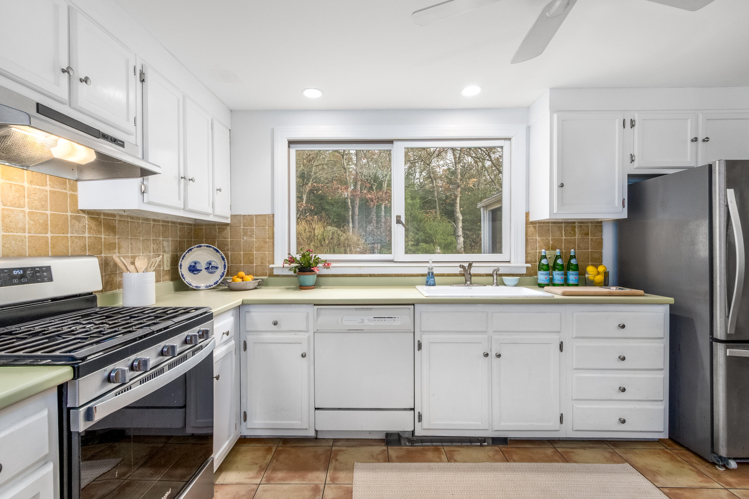 3 Tern Road Harwich, MA 02645 - Photo 9 of 44 a kitchen with granite countertop a stove a sink and a refrigerator