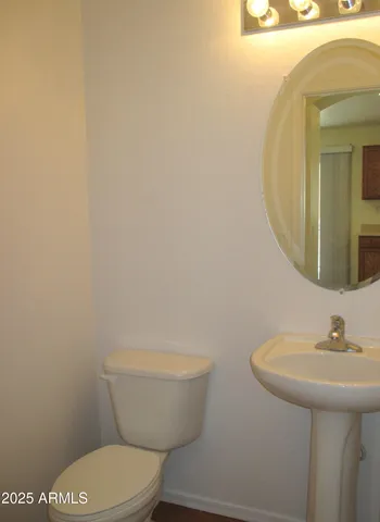 a white toilet sitting next to a bathroom sink