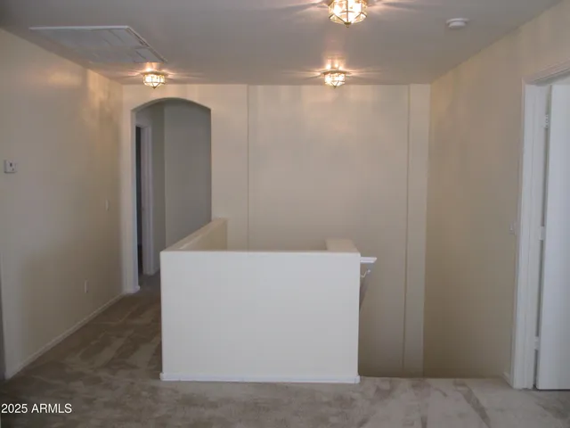 a room with a light fixture and a chandelier fan