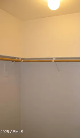 a view of a room with a ceiling fan and wooden floor