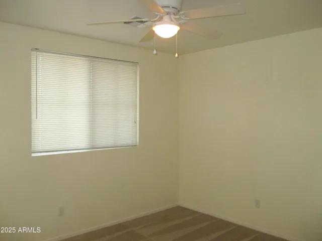a view of a small space with wooden floor and a window