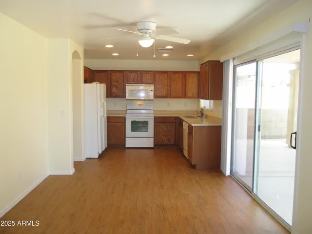 a kitchen with stainless steel appliances granite countertop a refrigerator and a sink