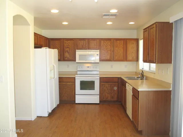 a kitchen with a sink a stove and refrigerator