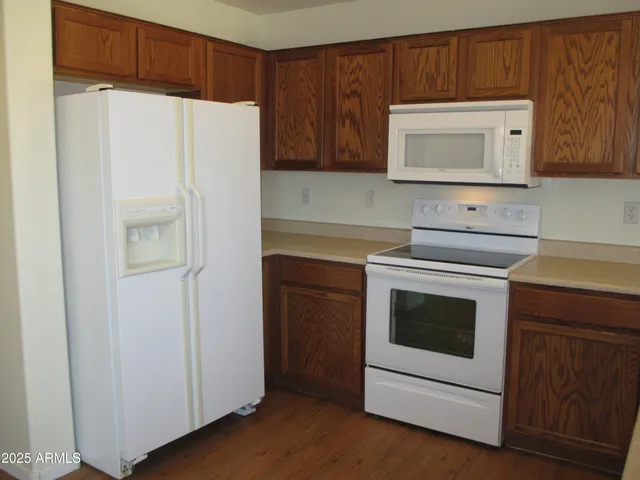 a kitchen with cabinets and white stainless steel appliances