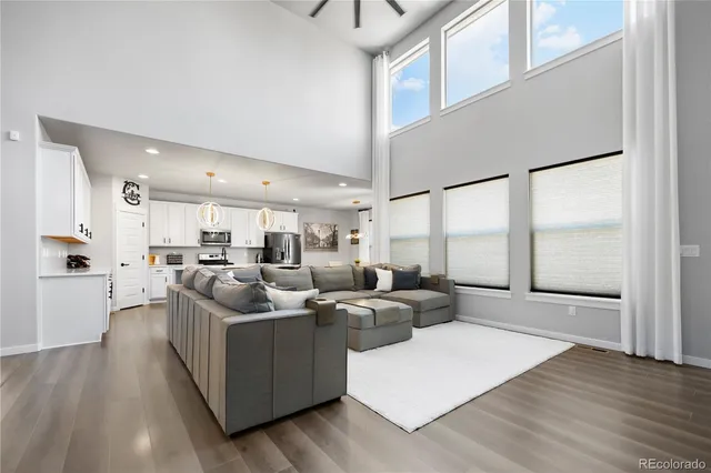 a living room with furniture window and wooden floor