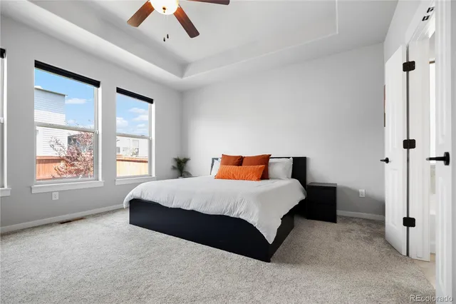 a spacious bedroom with a bed and a large window