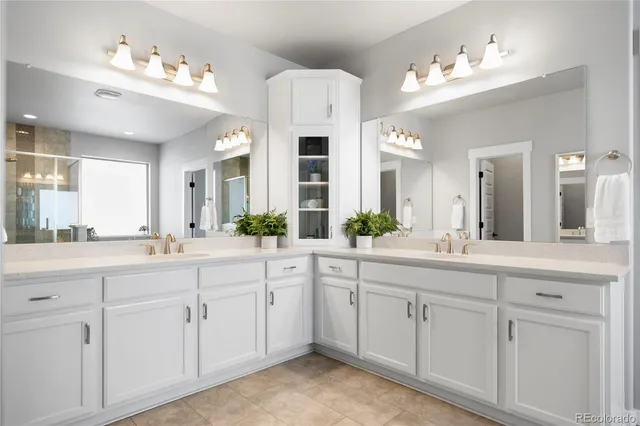 a spacious en suite bathroom with a sink double and mirror