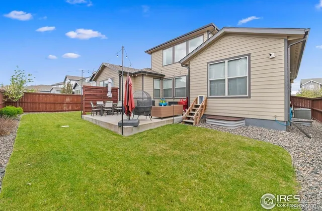 a view of a house with backyard porch and sitting area