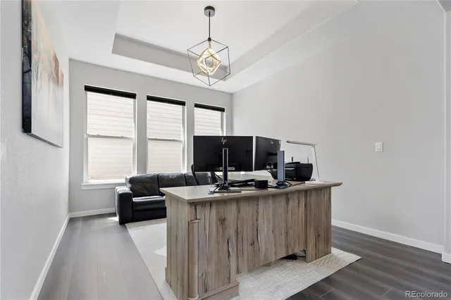 a view of a workspace with furniture and a window