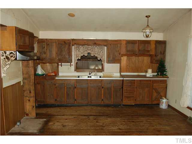 3529 Sturdivant Street Raleigh, NC 27610 - Photo 3 of 13 Partial View of Kitchen With Wood Cabinetry and REAL Wood Flooring!