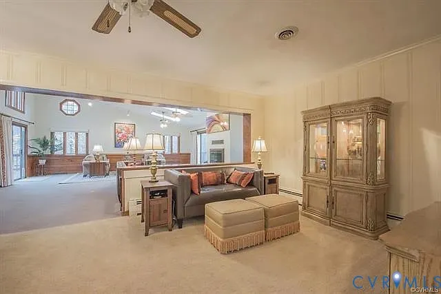 a view of a dining room with furniture a fireplace and chandelier