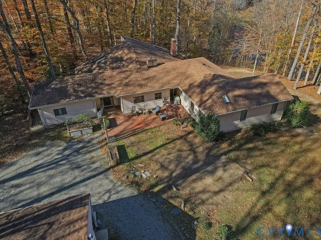 a view of a forest with mountains in the background