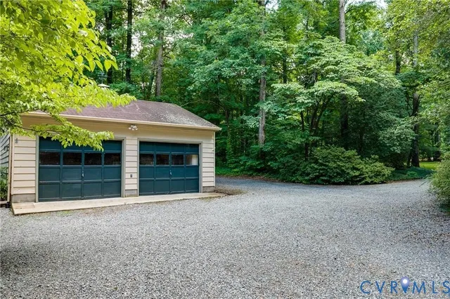 a view of a house with a yard and garage