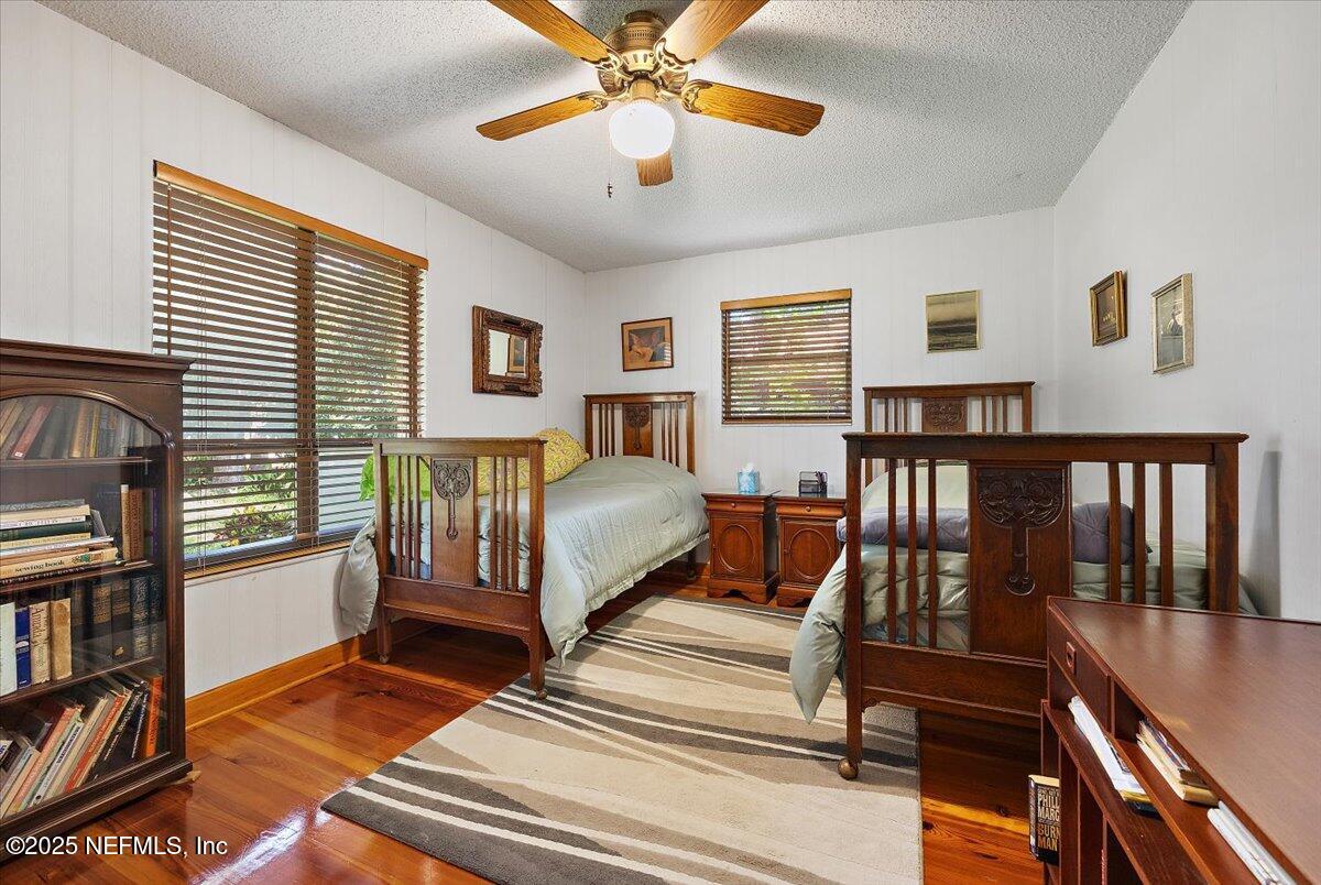 10567 Scott Mill Road Jacksonville, FL 32257 - Photo 17 of 28 a bedroom with furniture and a book shelf