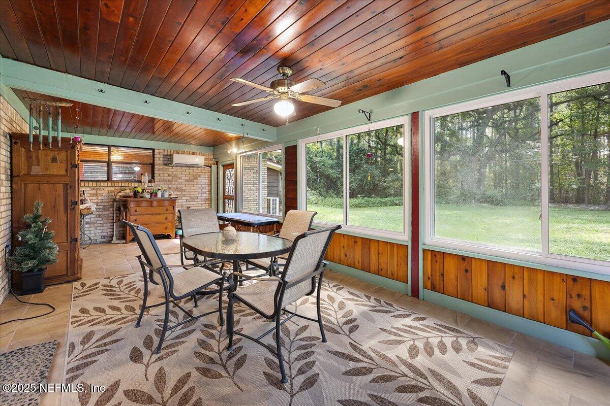 10567 Scott Mill Road Jacksonville, FL 32257 - Photo 18 of 28 a view of a patio with table and chairs and wooden floor