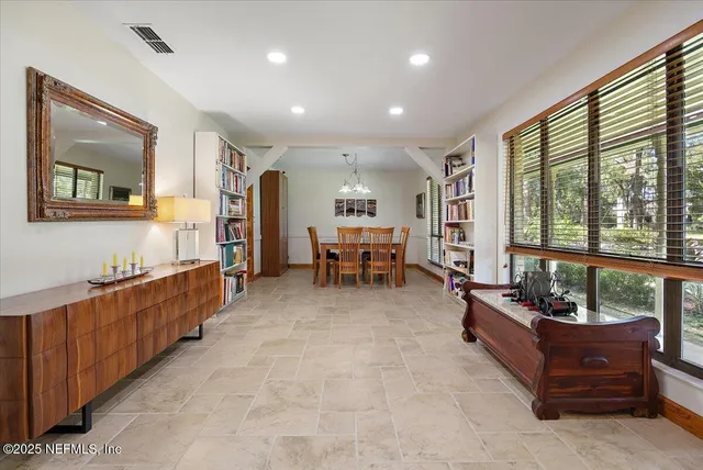a view of a dining room with furniture and a chandelier