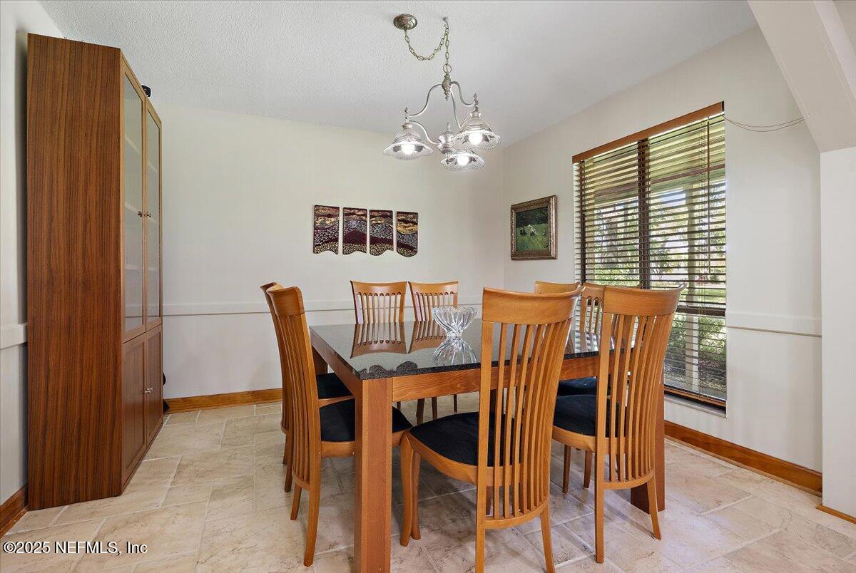 10567 Scott Mill Road Jacksonville, FL 32257 - Photo 5 of 28 a view of a dining room with furniture and a chandelier