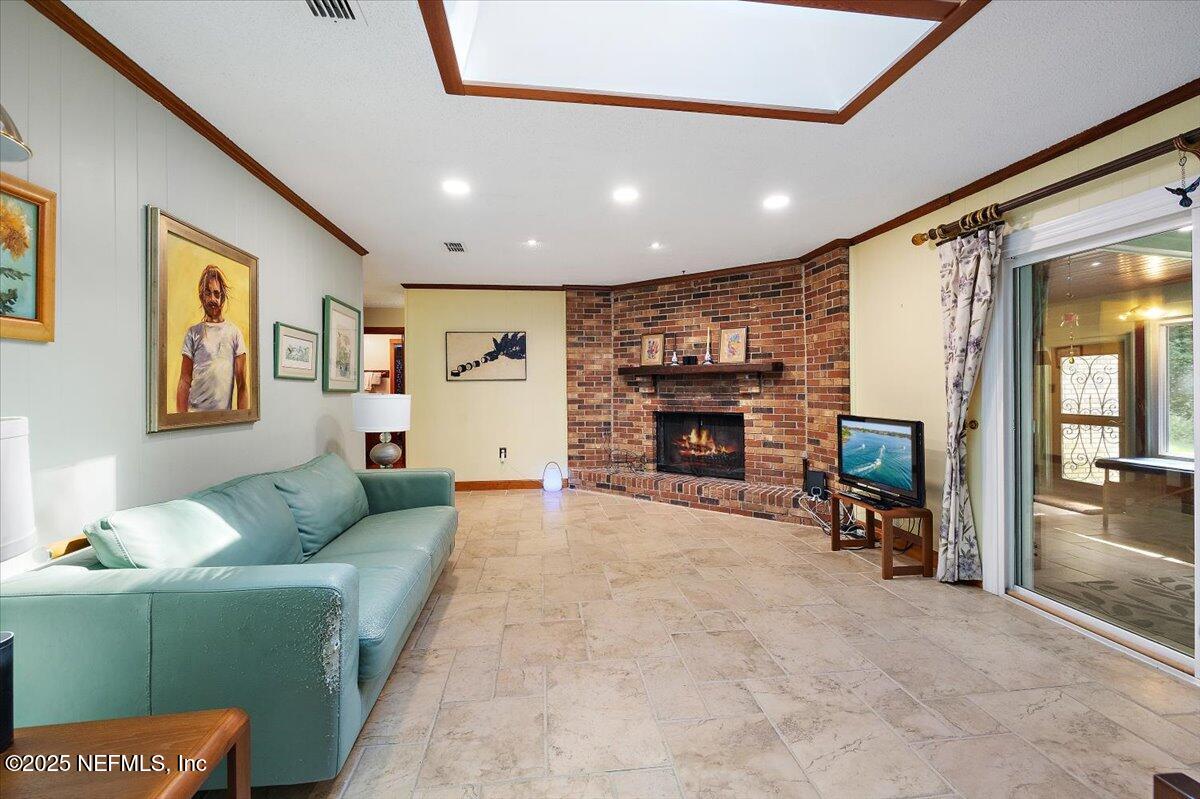 10567 Scott Mill Road Jacksonville, FL 32257 - Photo 9 of 28 a living room with furniture and a fireplace