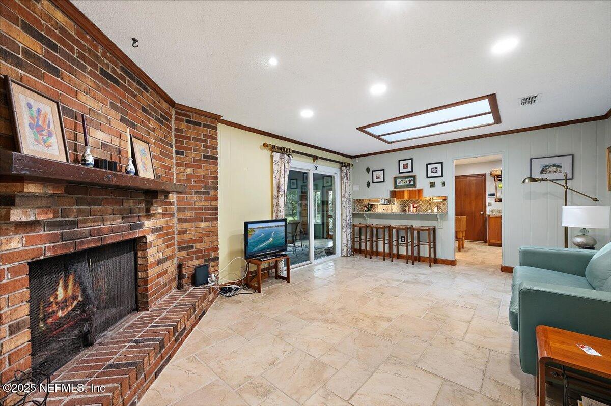 10567 Scott Mill Road Jacksonville, FL 32257 - Photo 10 of 28 a living room with furniture and a fireplace