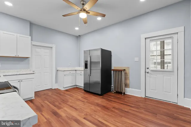 a view of a kitchen with a sink and a refrigerator