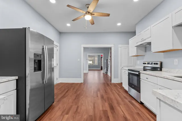 a kitchen with stainless steel appliances a refrigerator sink and stove