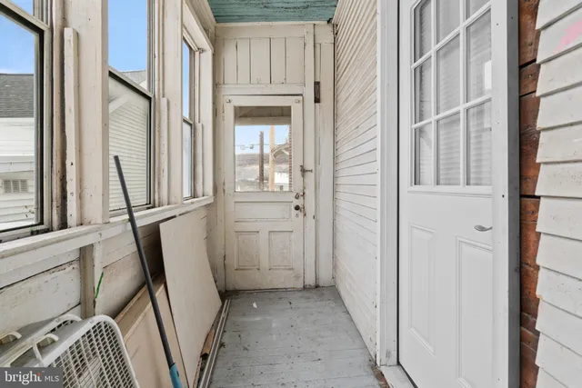 a view of white house with a snow in the yard