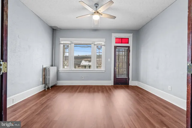 wooden floor in an empty room with a window
