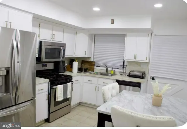 a kitchen with a stove a sink and a refrigerator