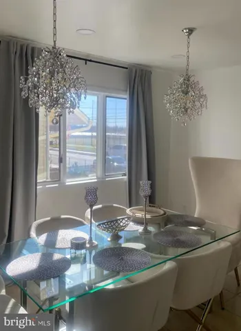 a room with a chandelier and large windows