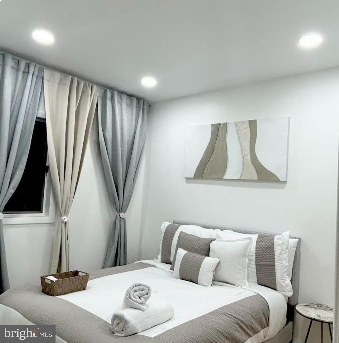 182 Mehrhof Road, Unit 2 Little Ferry, NJ 07643 - Photo 6 of 12 a bedroom with a bed and a flat screen tv