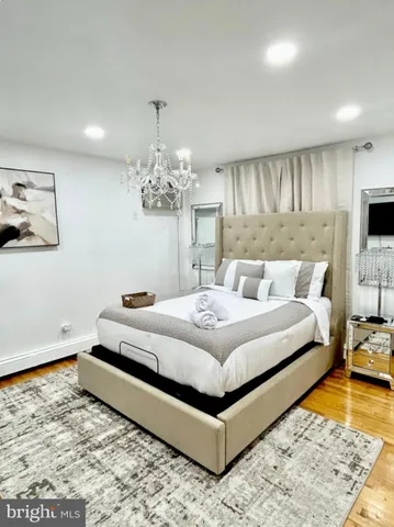 a bedroom with a bed and a chandelier