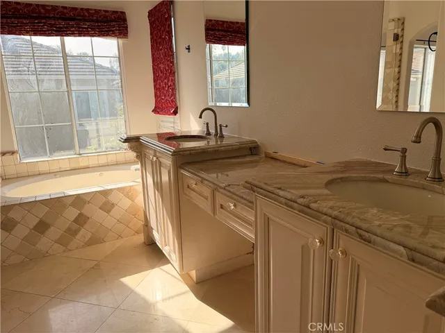 a view of a small space with wooden floor and windows