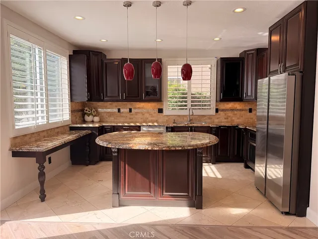 a kitchen with stainless steel appliances granite countertop a stove and a refrigerator