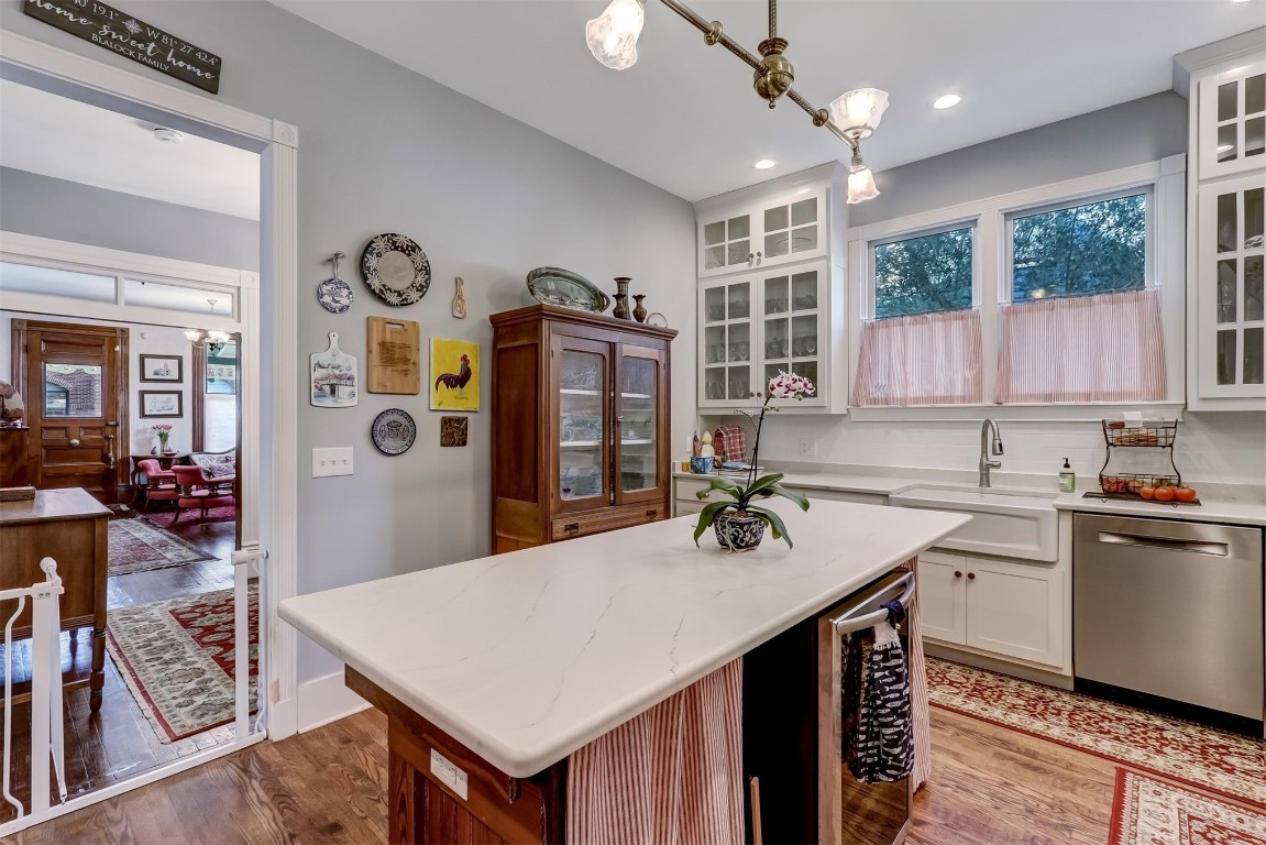 22 North 4th Street Fernandina Beach, FL 32034 - Photo 20 of 100 a kitchen with a stove a refrigerator and a dining table with wooden floor