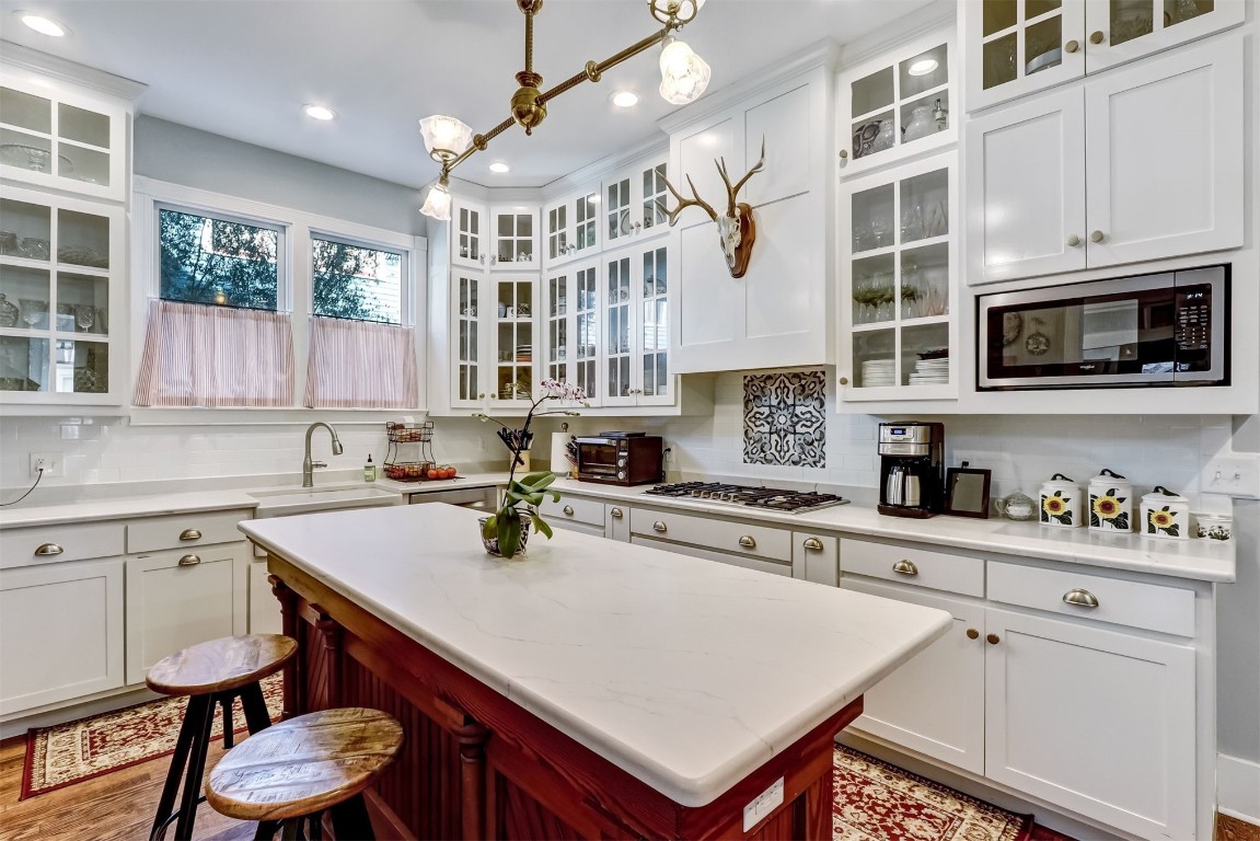 22 North 4th Street Fernandina Beach, FL 32034 - Photo 25 of 100 a kitchen with a sink a stove and cabinets
