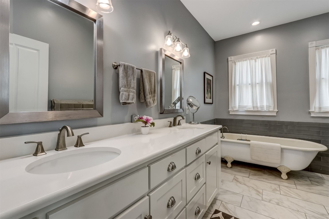 22 North 4th Street Fernandina Beach, FL 32034 - Photo 33 of 100 a bathroom with a double vanity sink large mirror and bathtub