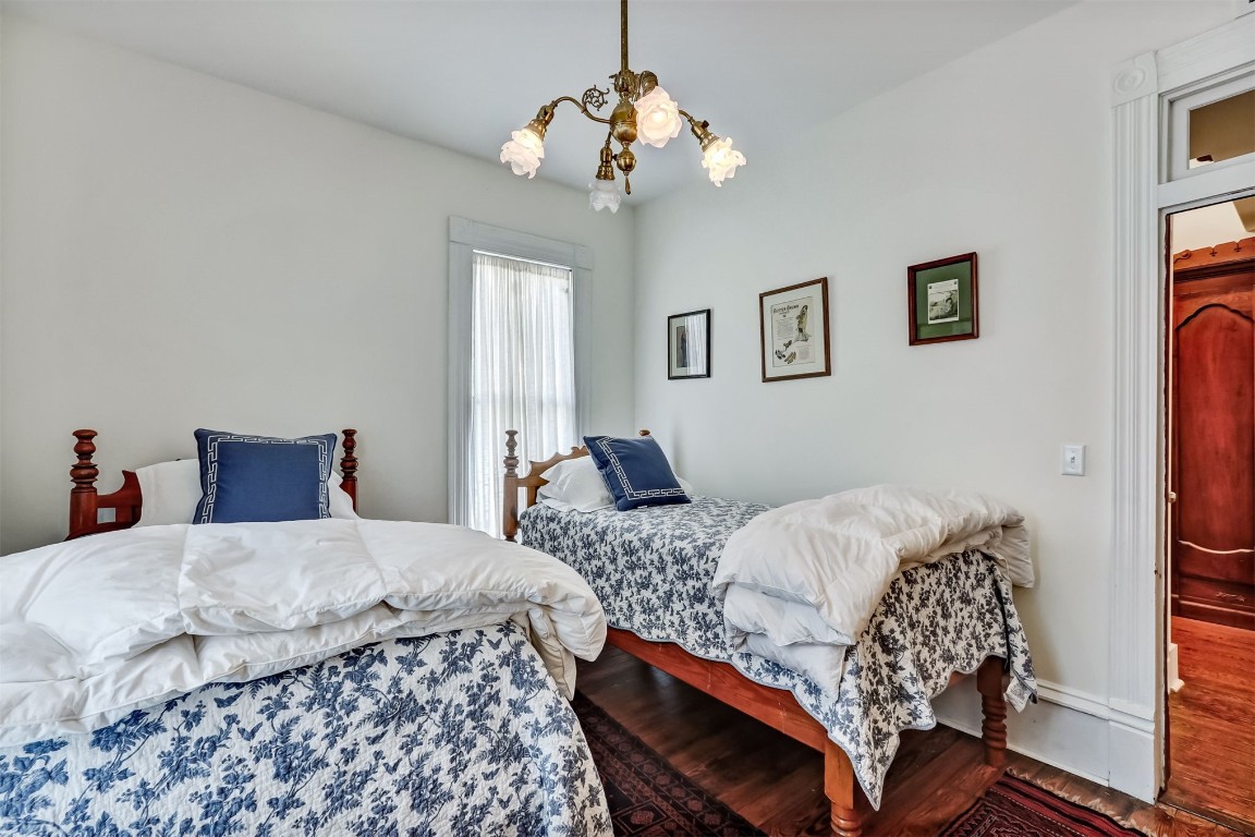 22 North 4th Street Fernandina Beach, FL 32034 - Photo 39 of 100 a bedroom with bed and a chandelier