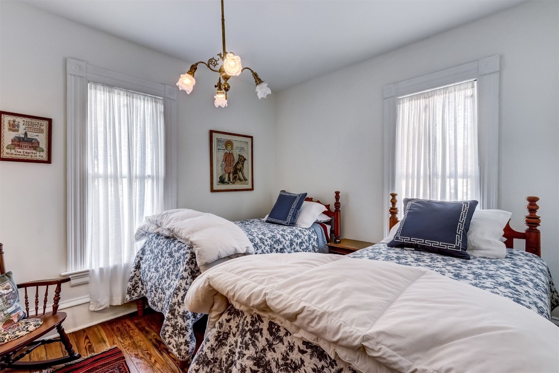 22 North 4th Street Fernandina Beach, FL 32034 - Photo 40 of 100 a bedroom with two beds and a chandelier