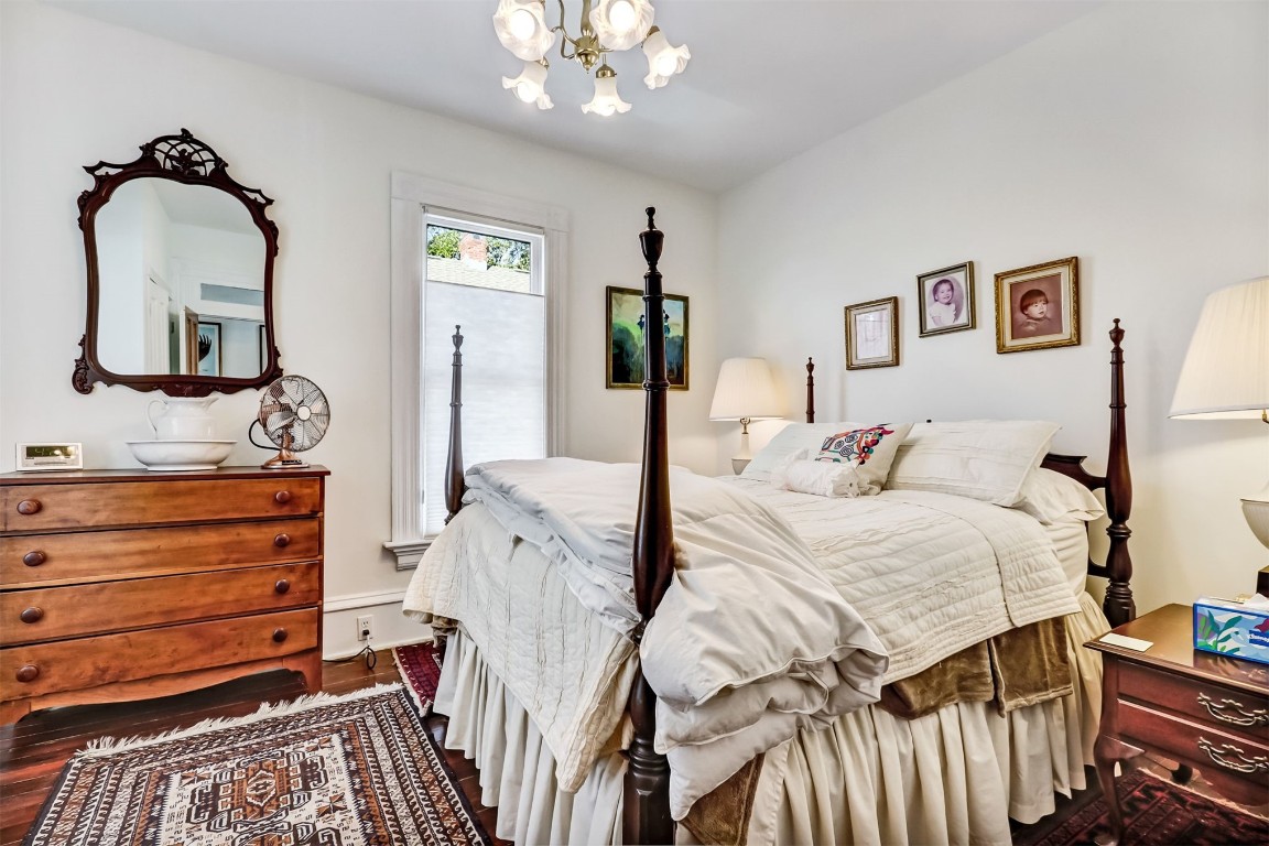 22 North 4th Street Fernandina Beach, FL 32034 - Photo 46 of 100 a bedroom with a bed and a mirror on dresser